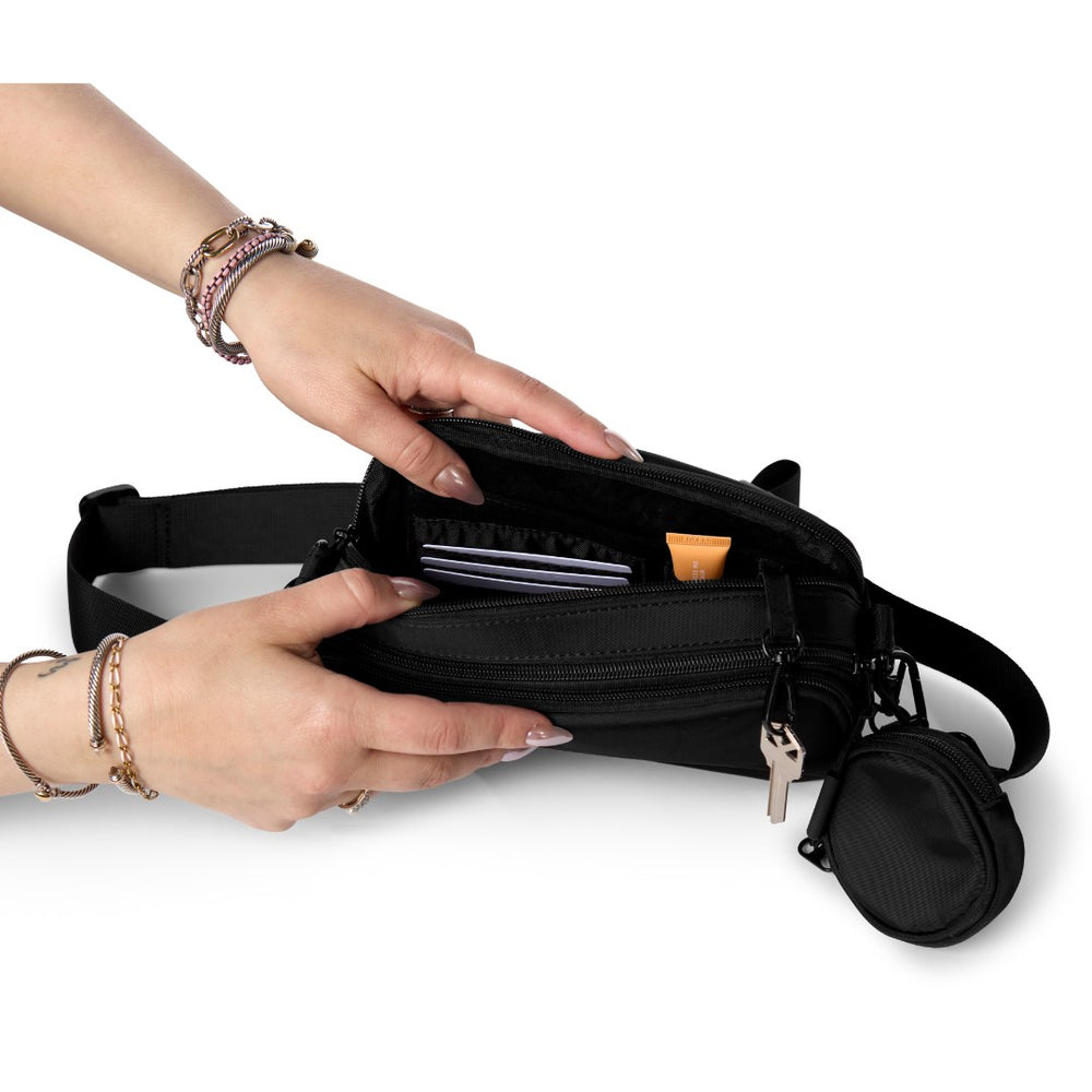 Hands opening a Hello Clio bag to show its pockets